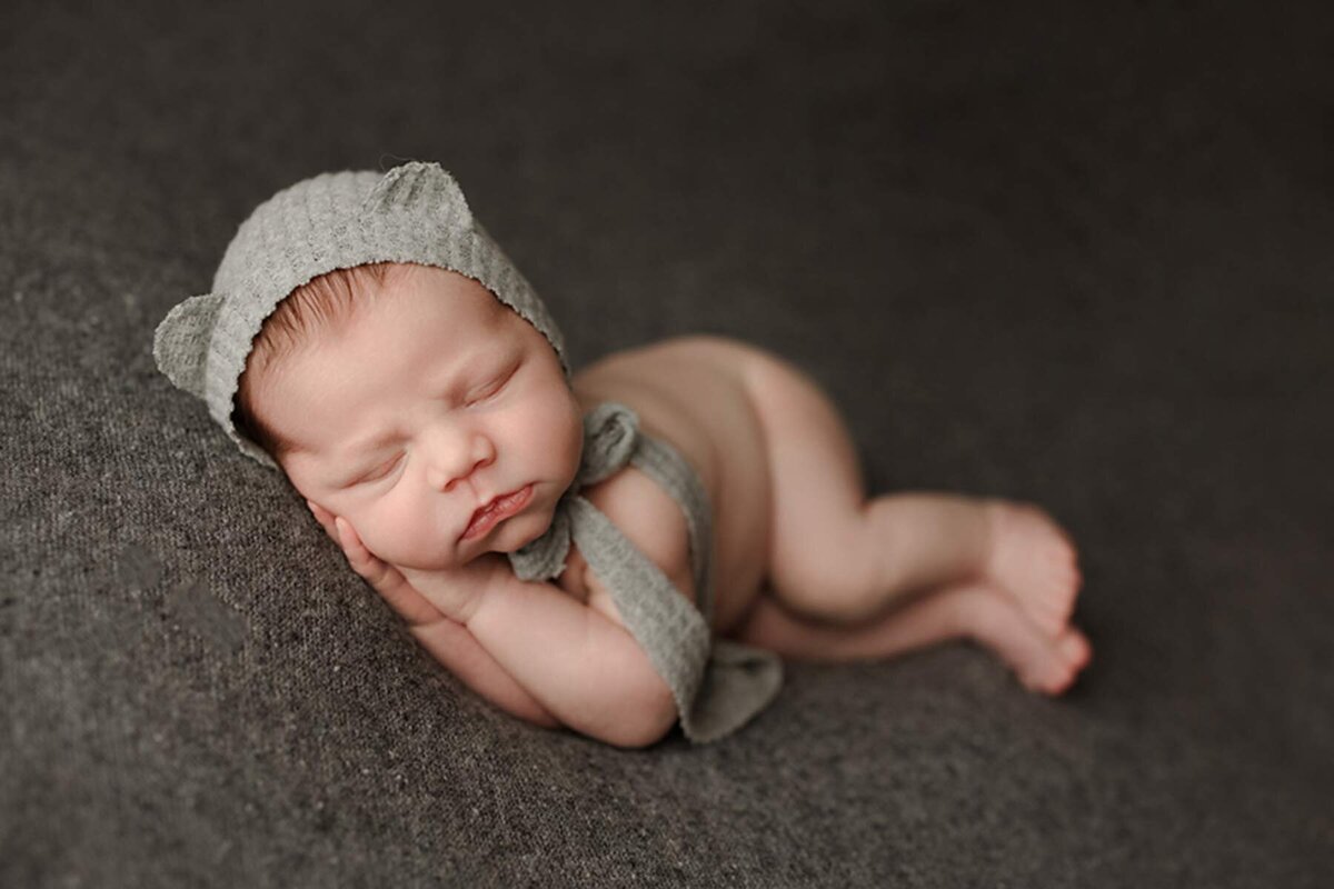 Artistic newborn portrait of baby with hat prop