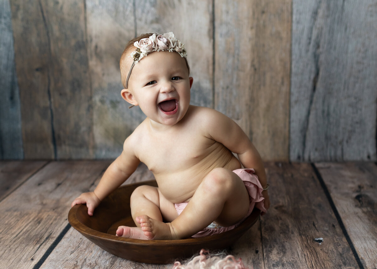 baby girl laughing for photo