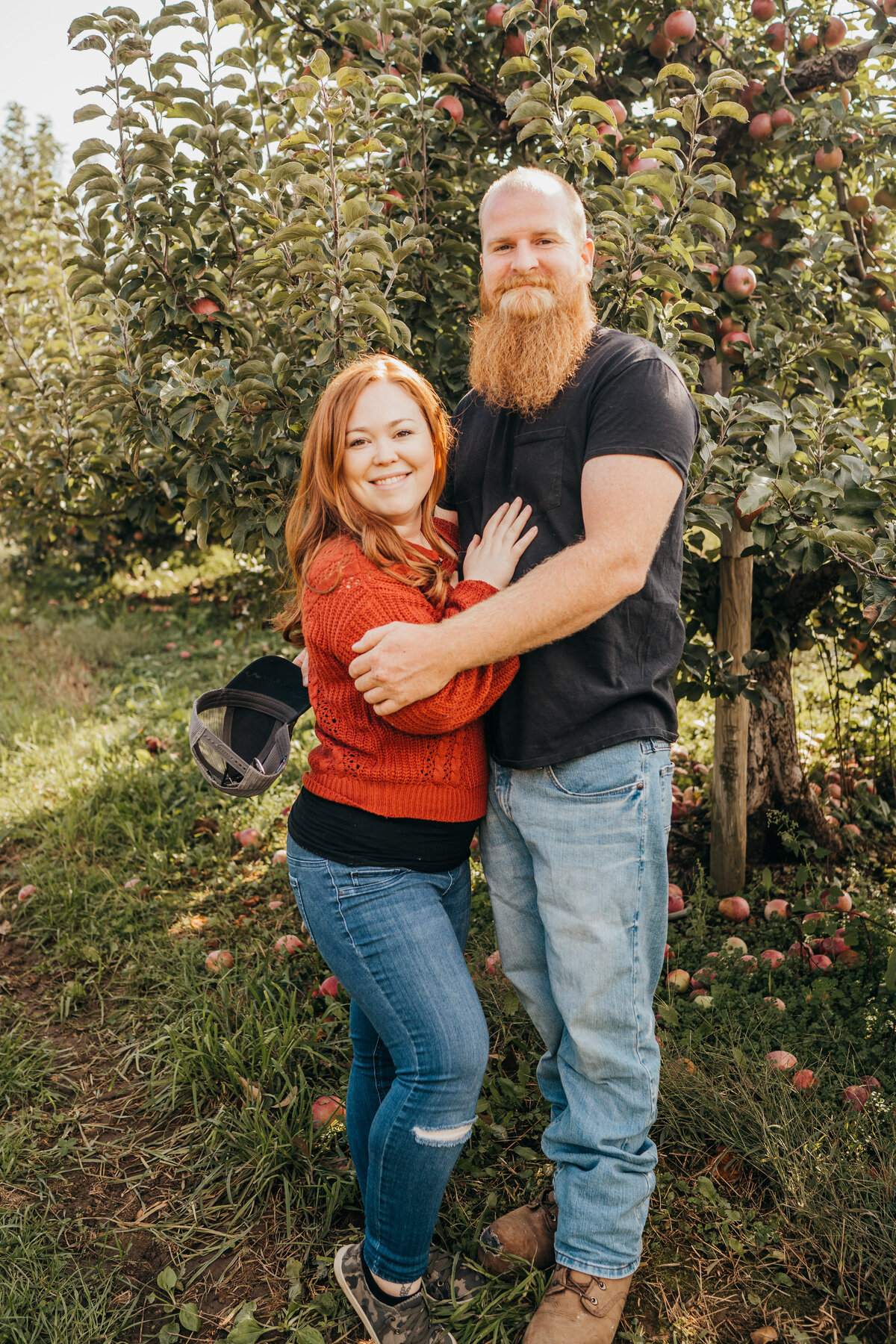 couple embracing on apple orchard