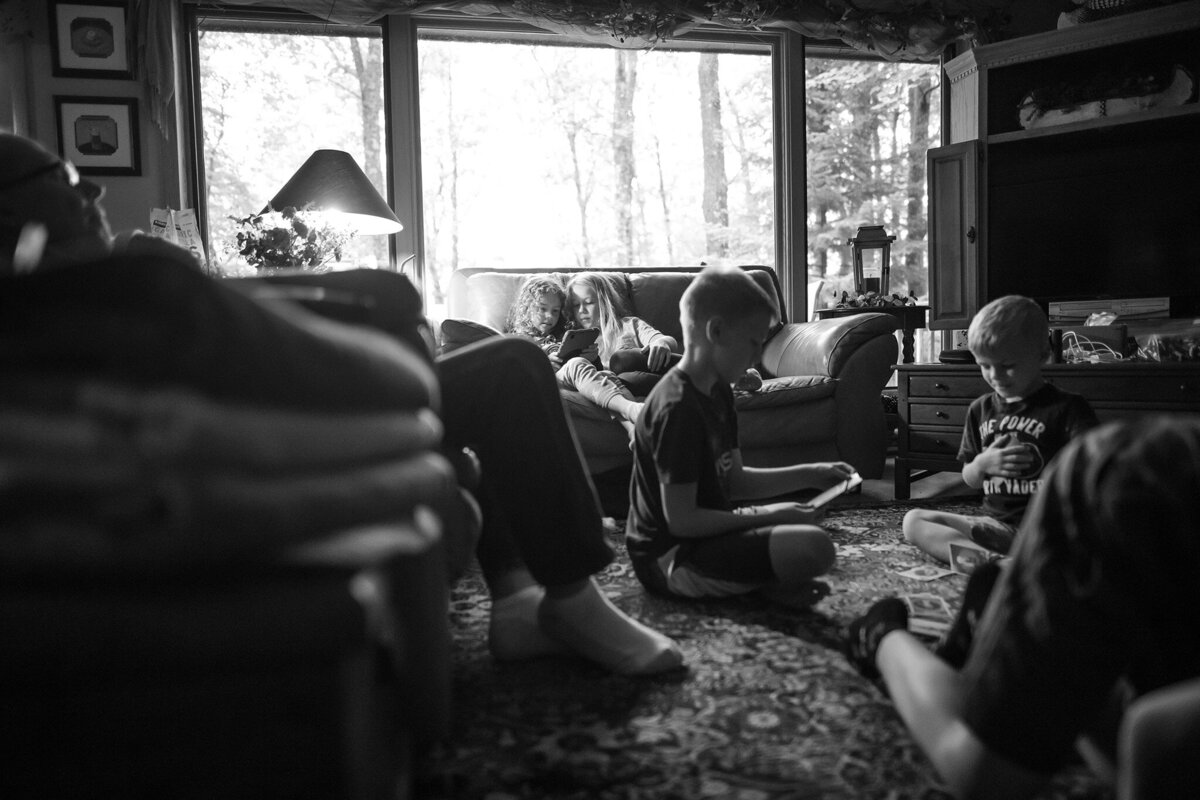 cousins at the cabin reading on the couch