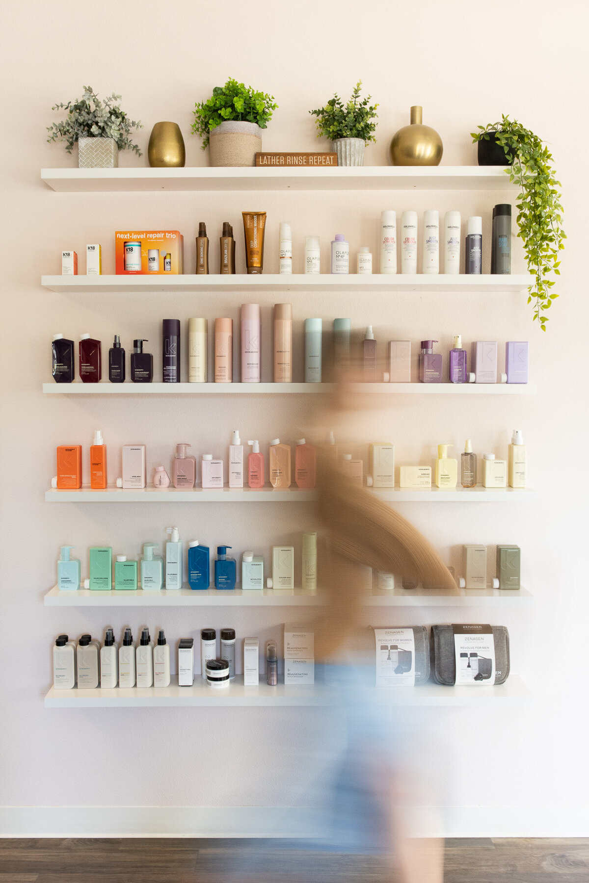 Branding photoshoot in Portland Oregon salon features products on wall. 