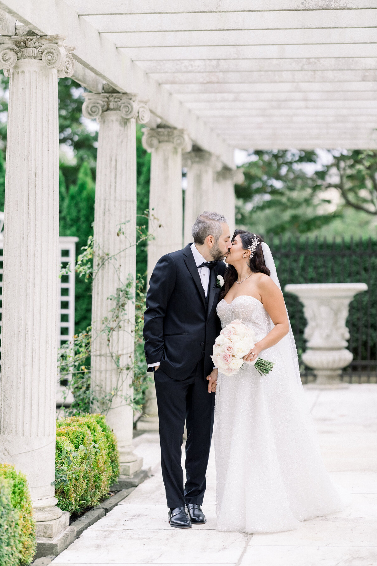 bride and groom walk through the gardens of rosecliff mansion in newport rhode island