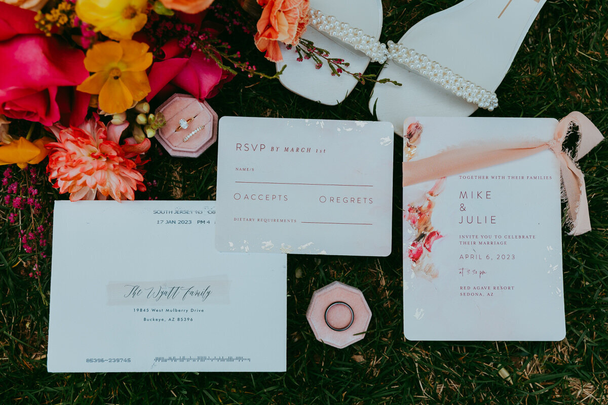 wedding invitations on a grassy backdrop