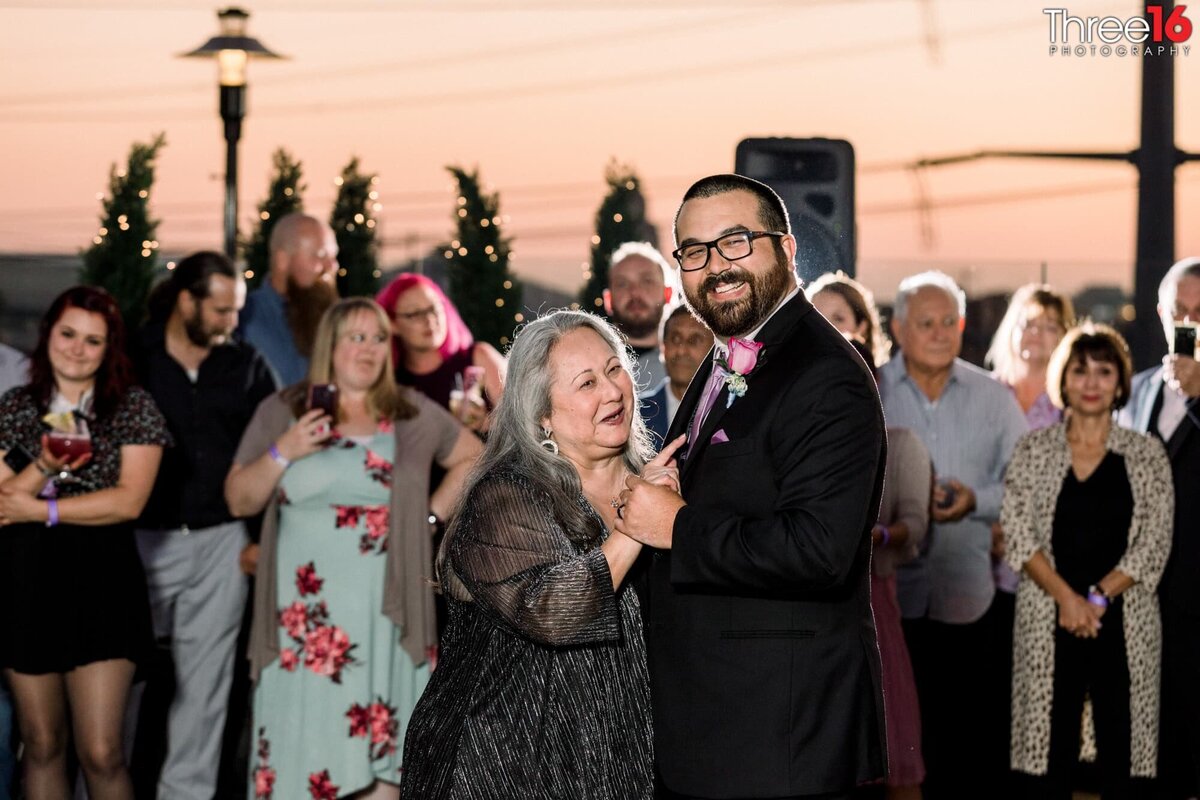 Groom dances with his mom at his wedding reception