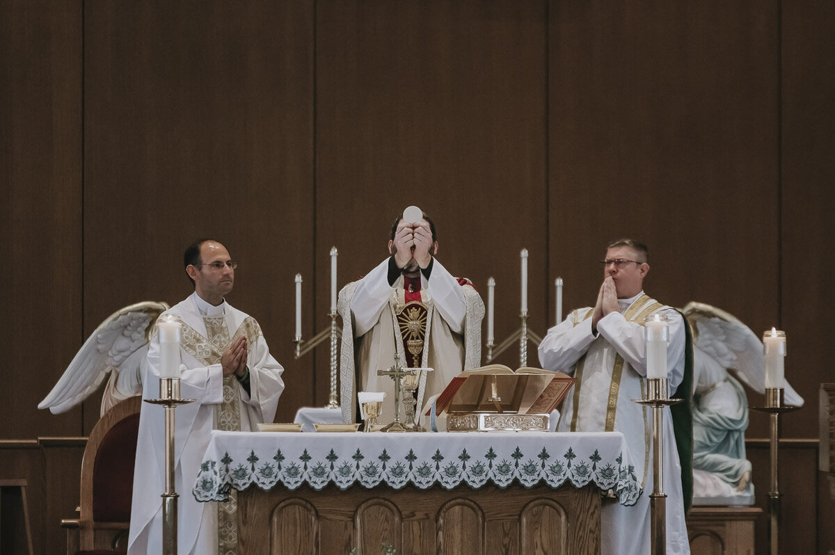 a Catholic priest officiating a wedding ceremony