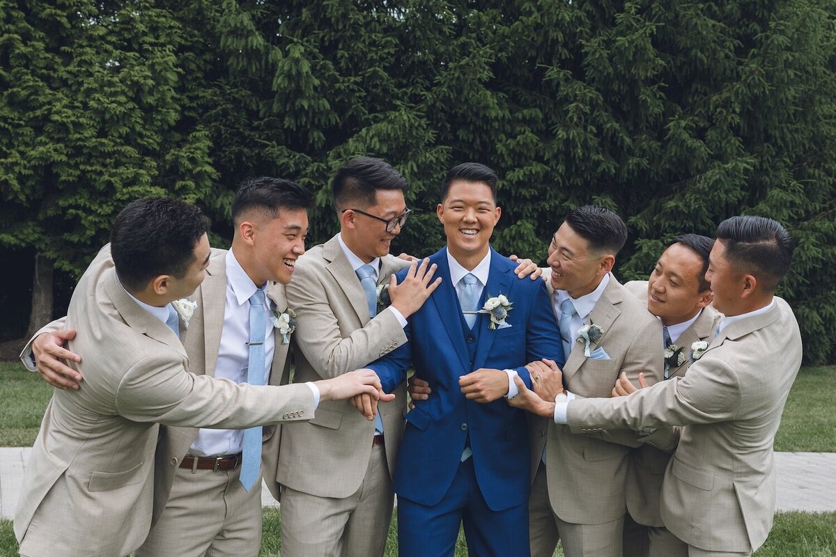 Groom with groomsmen in tan suits