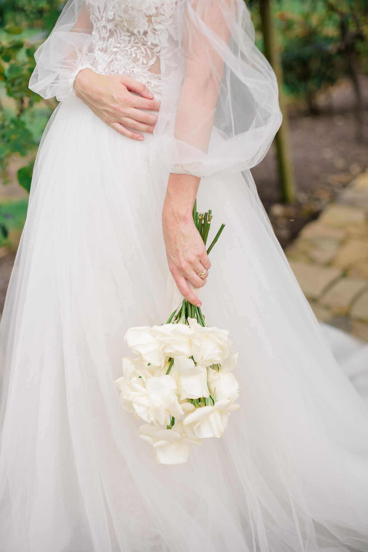 Bride holding bouquet at Running Hare Vineyard. Captured by Washington DC Wedding Photographer Bethany Aubre Photography.