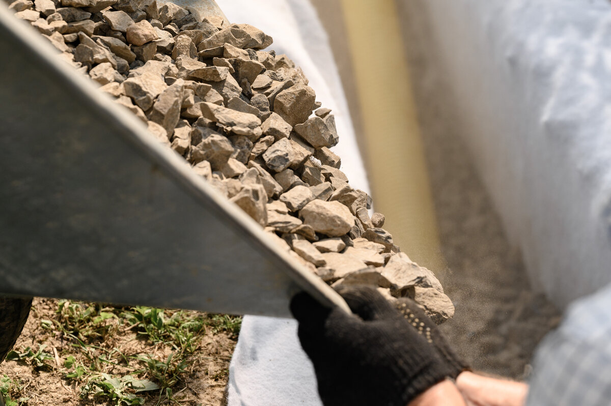 dumping rocks into a landscaping garden bed