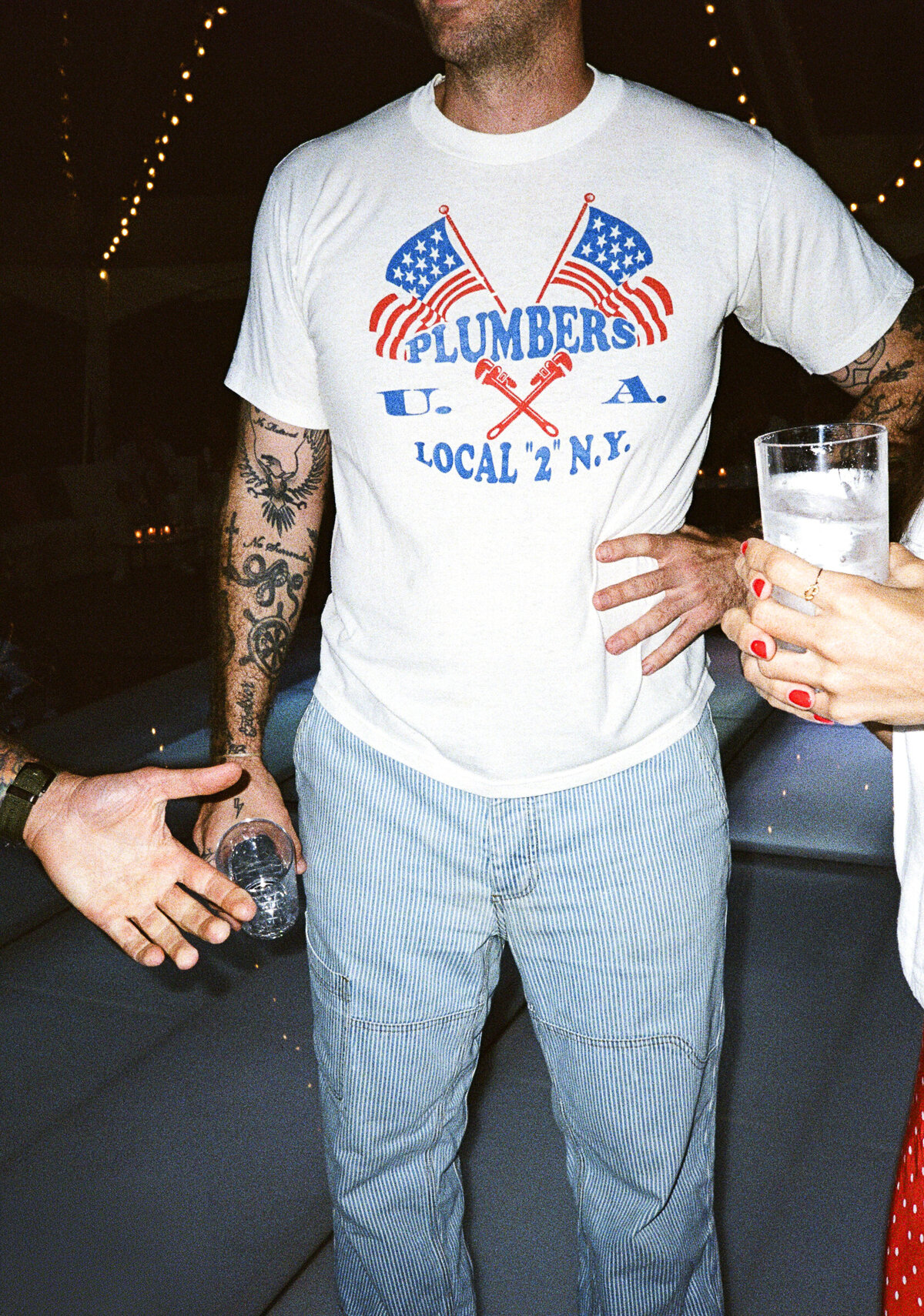 Photo of guest's plumbers local 2 NY shirt on film in private backyard party by Mira Park Photography NY based wedding photographer