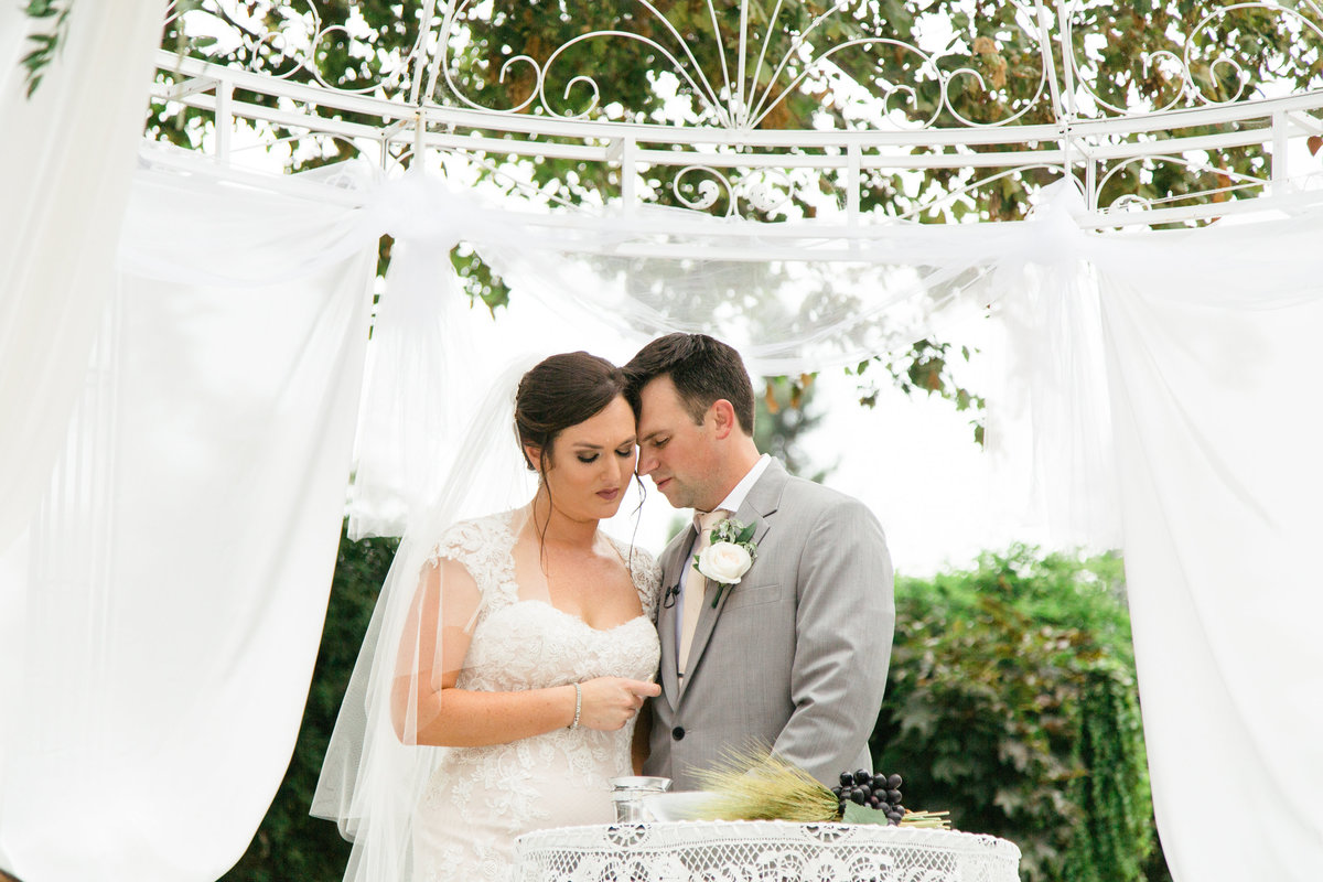 Bride and groom pray at 1880 Union Hotel Wedding