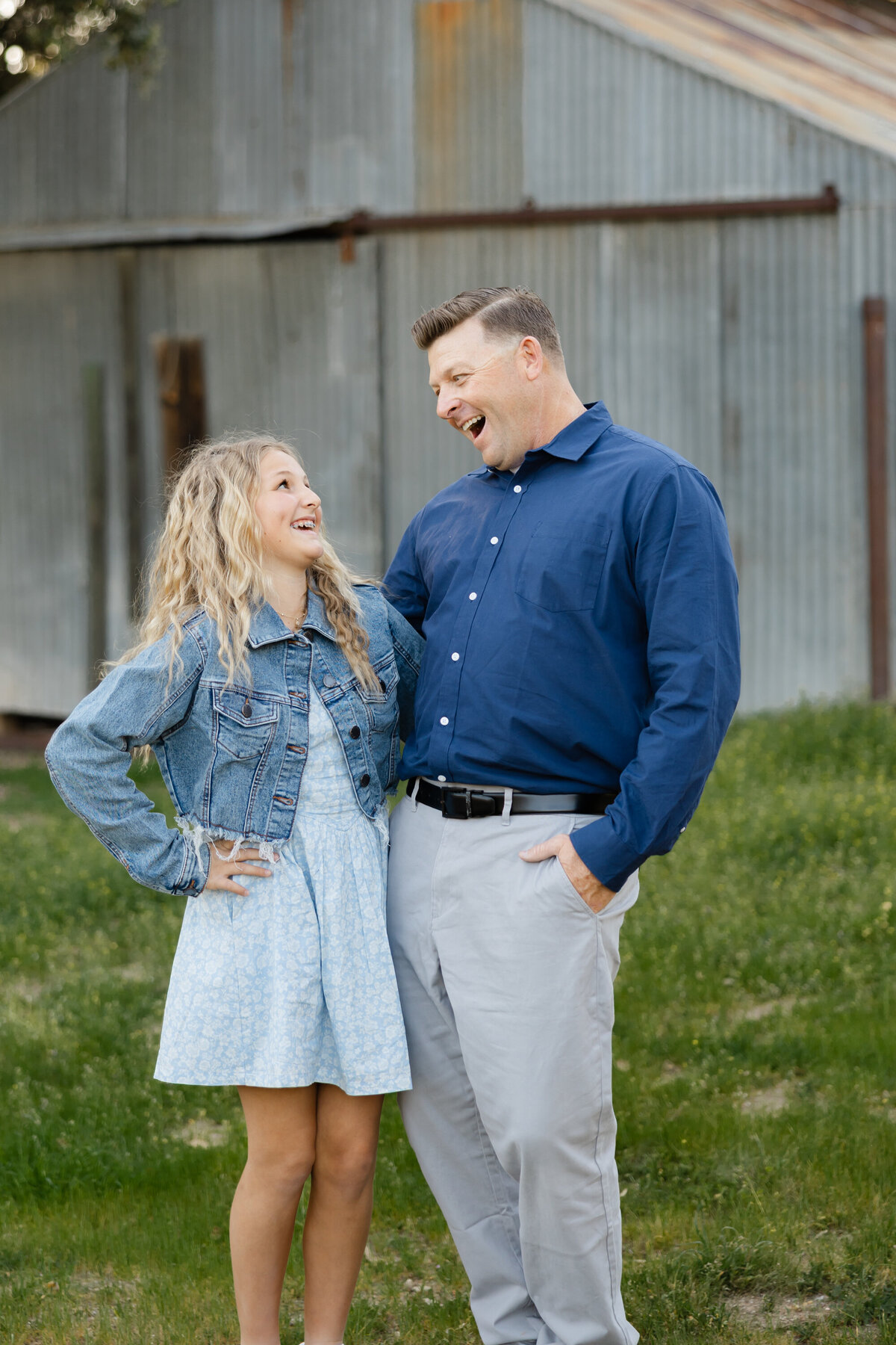 Father standing with teenage daughter outdoors, dressed in denim and neutrals. Photographed by Yucaipa family photographer Kaitlyn Dawn Photography.
