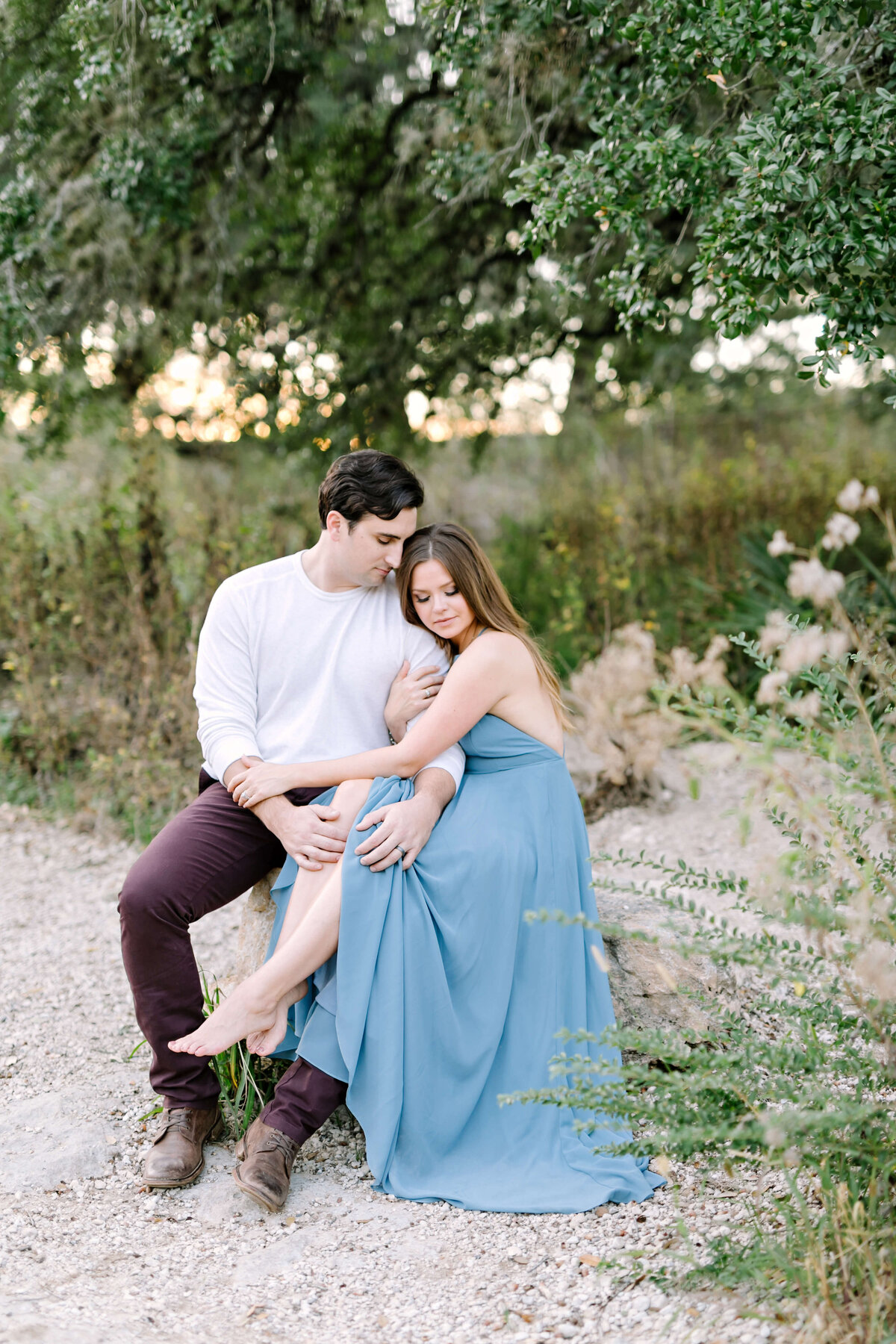 Couple holding hands and embracing at their Austin engagement session