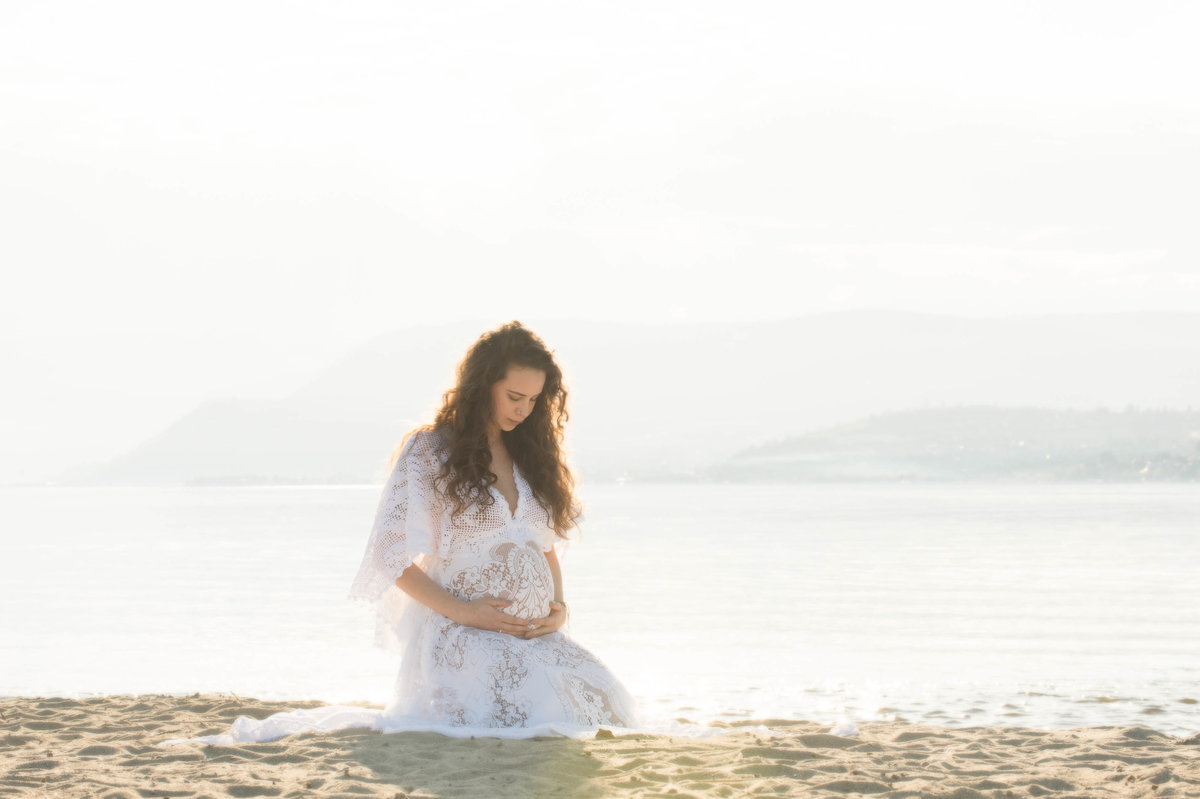 Boho chic Maternity photos in the summer on the lake backlit by the sun  in Kelowna . Dress by Reclamation