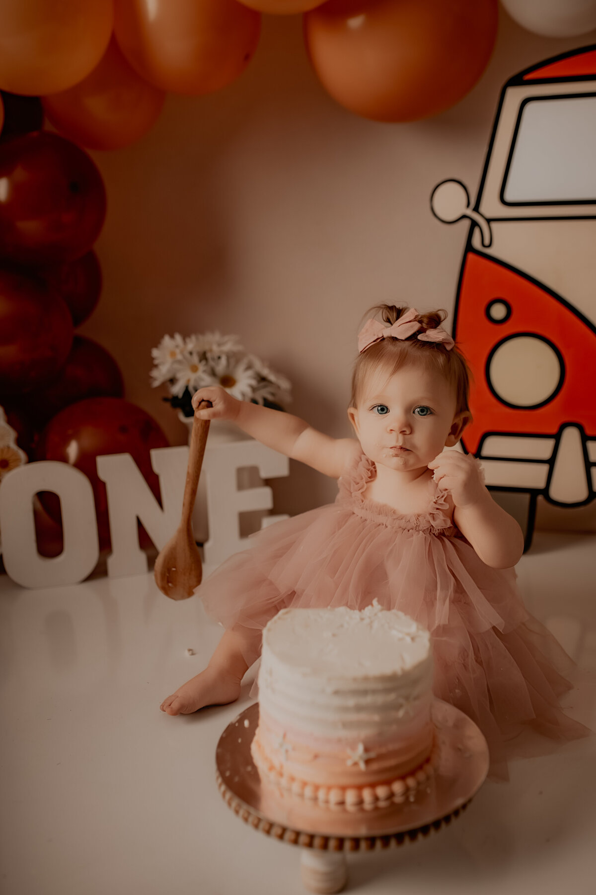 Atascocita, Tx little girl holding a spoon eating cake photo