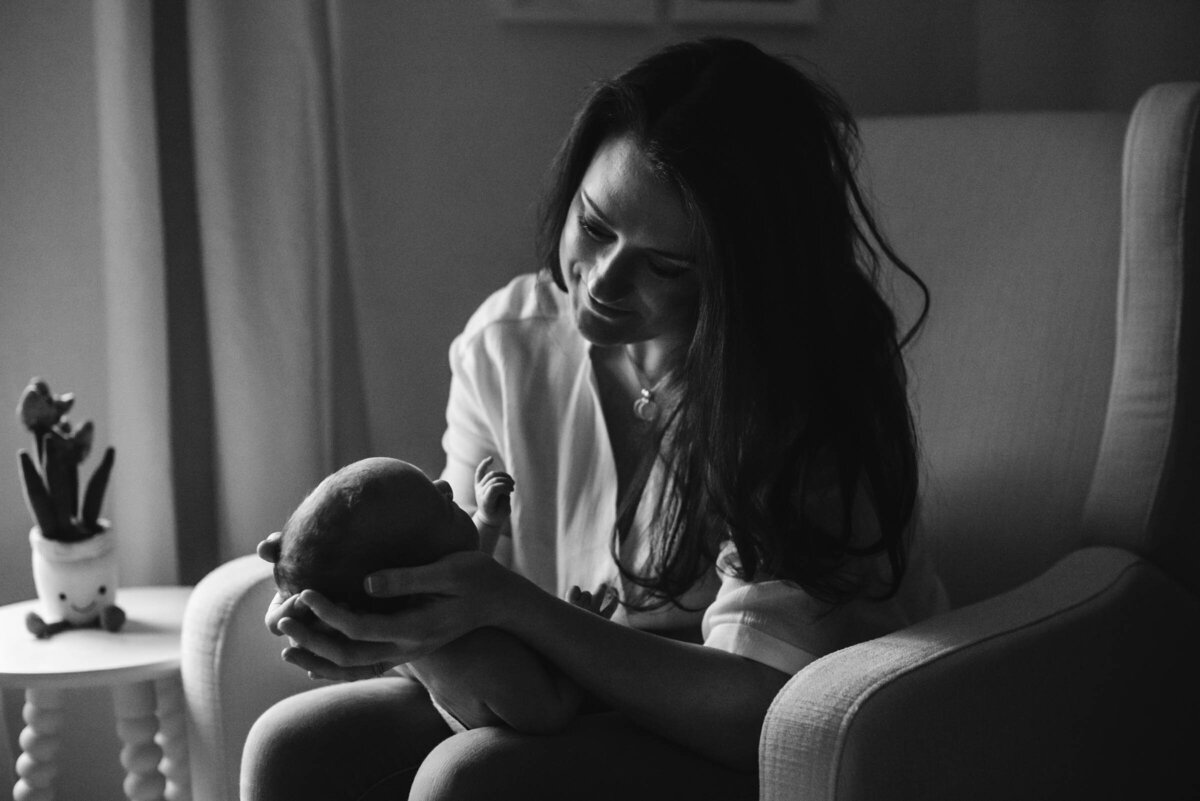 Black and white portrait of Mother holding newborn and gazing with love Newborn Portrait Photography