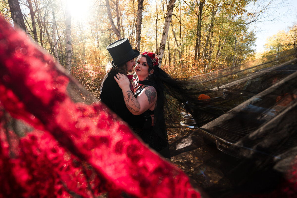 bride and groom look at each other in swooped veil photo