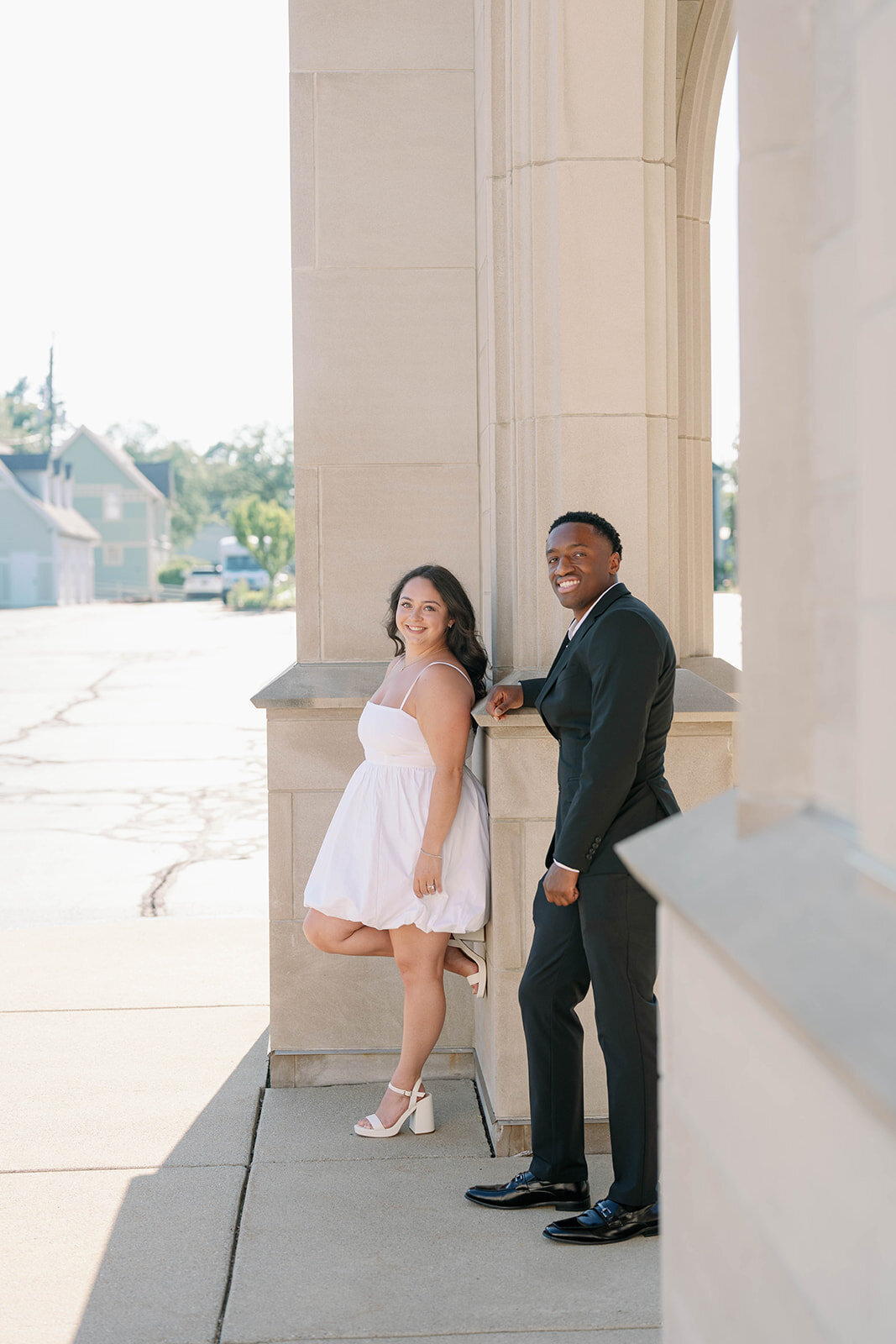 Bride-to-be smiling back at her fiancé during romantic Kalamazoo engagement photos.
