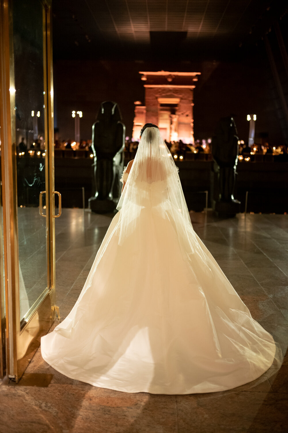 Bride in veil and train enter the Metropolitan museum of art wedding