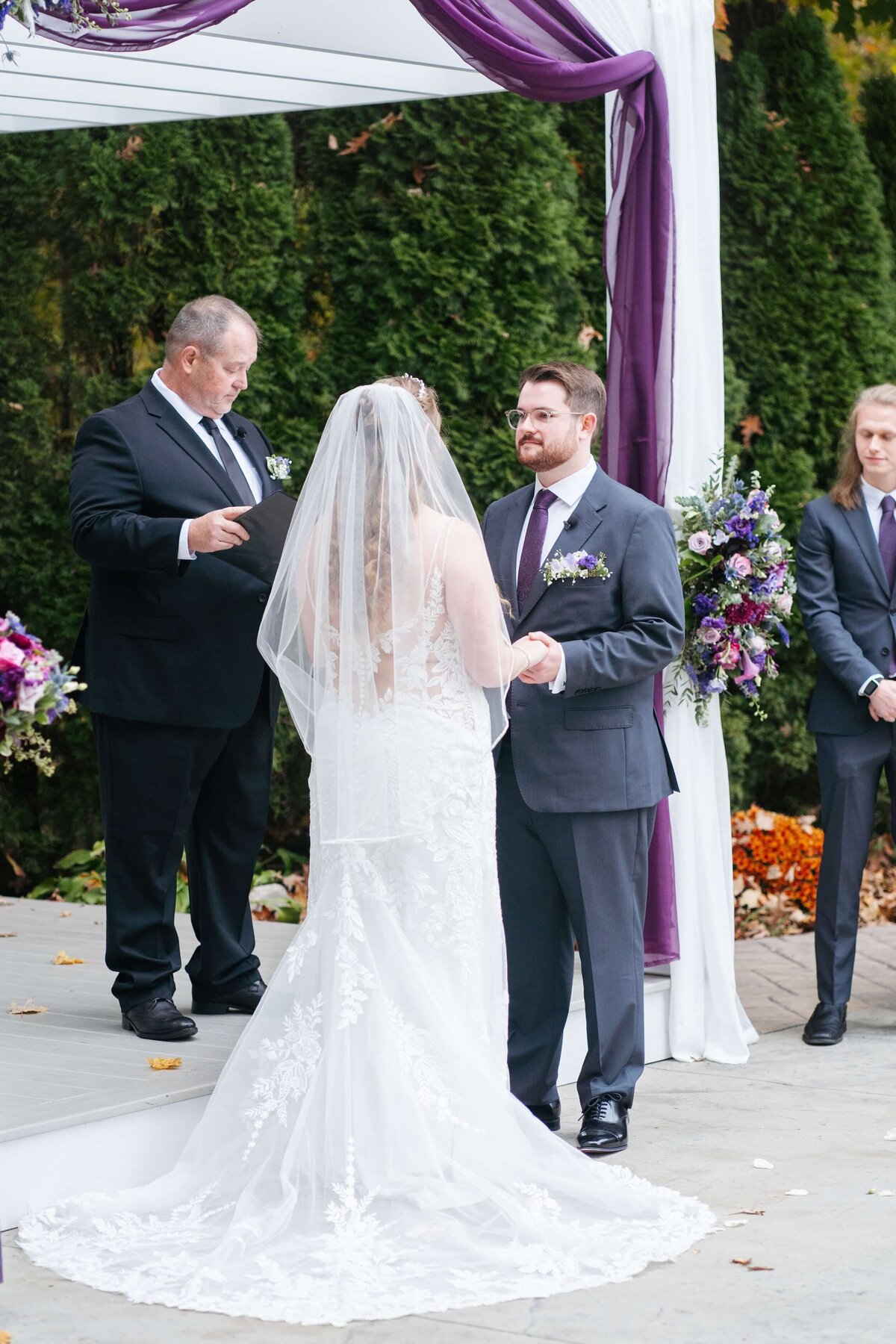 Bride and groom at ceremony exchanging vows 
