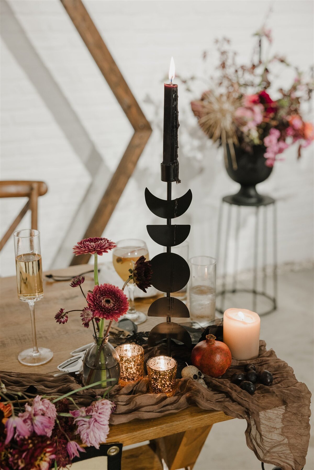 Black candles and burgundy flowers