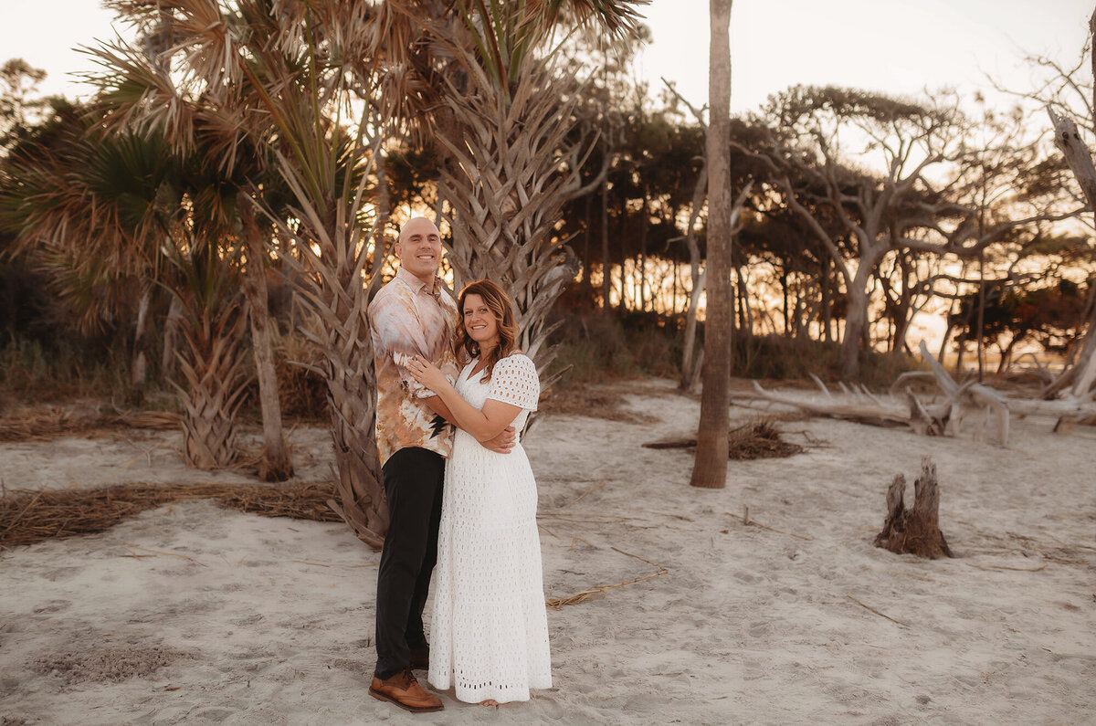 Couple embraces during Family Photoshoot on Folly Beach.