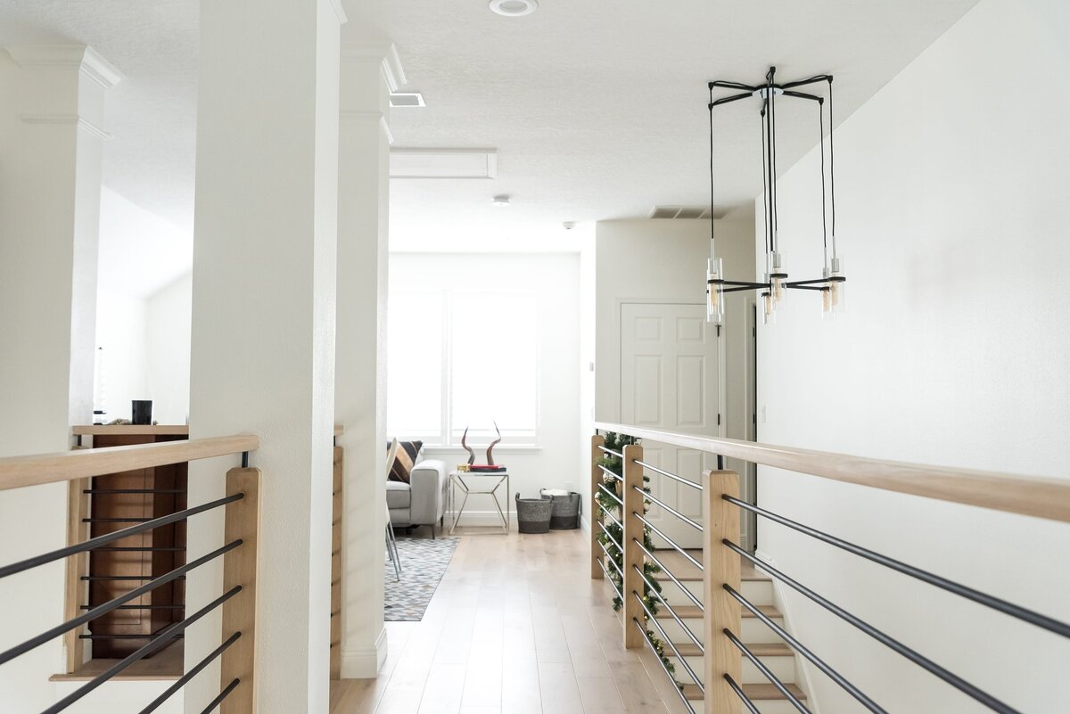 dewine design orlando interior designer modern lakehouse wood and black iron railing classic white walls