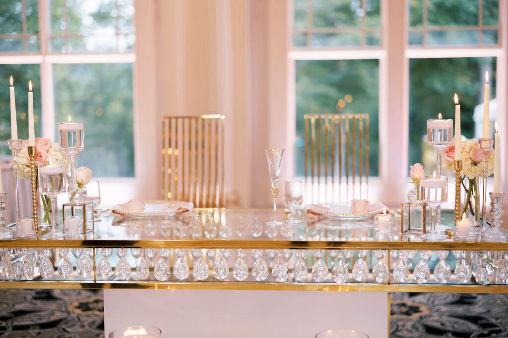 gold and glass table with pink and gold decor