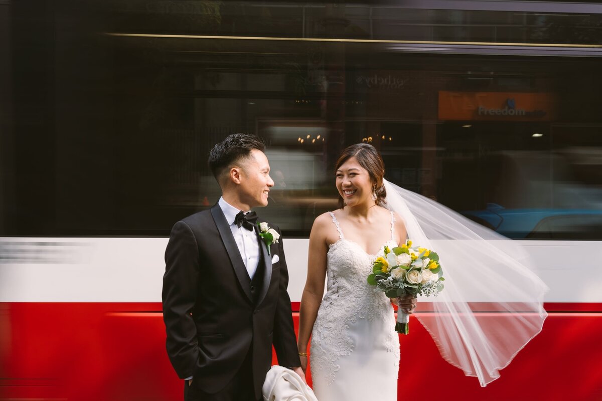 married couple in front of streetcar passing by