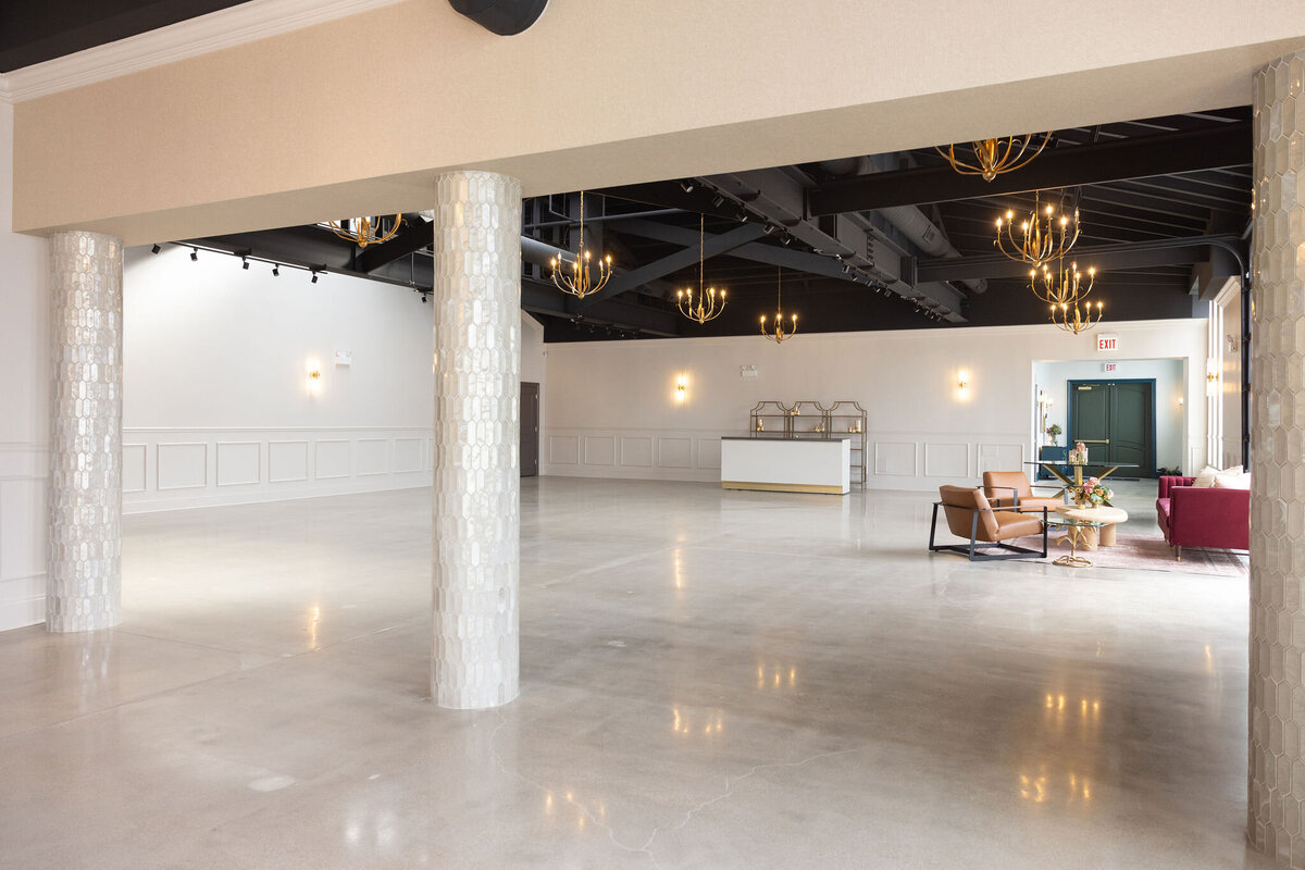 wide shot of timeless blank slate of the Happy Hour in Bloom Events, accented with romantic chandeliers and natural light, event space for wedding ceremony, reception, corporate or social event