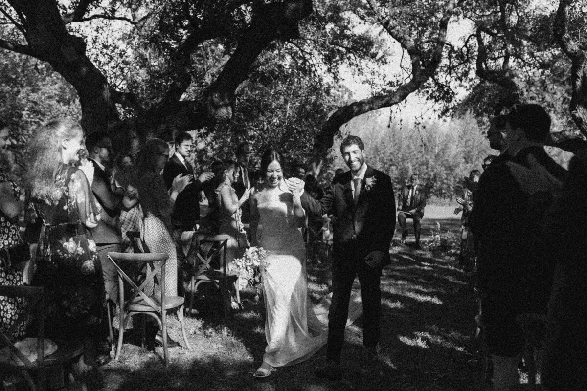 Bride and groom walking down the aisle at outdoor wedding ceremony at  Mattie's Austin