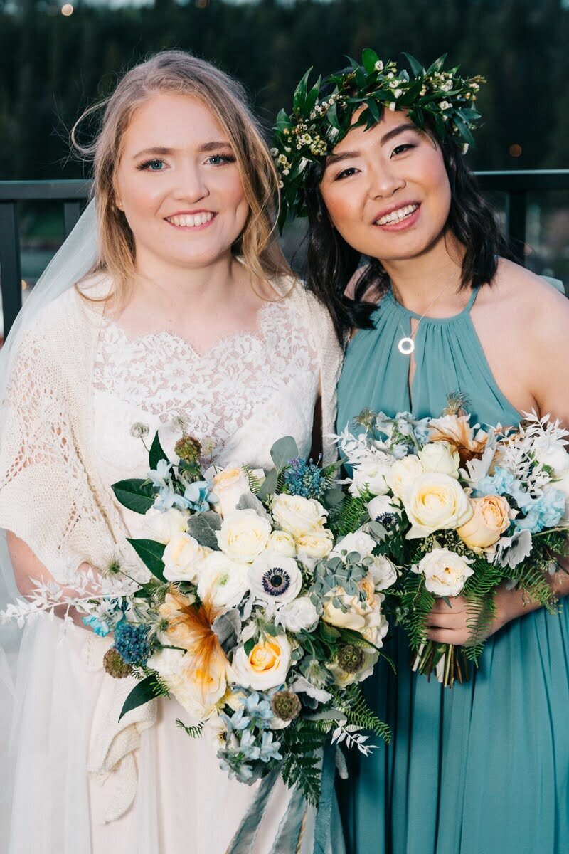 Bride and bridesmaid hold their bouquets by Eugene florist Flowers and Thyme.