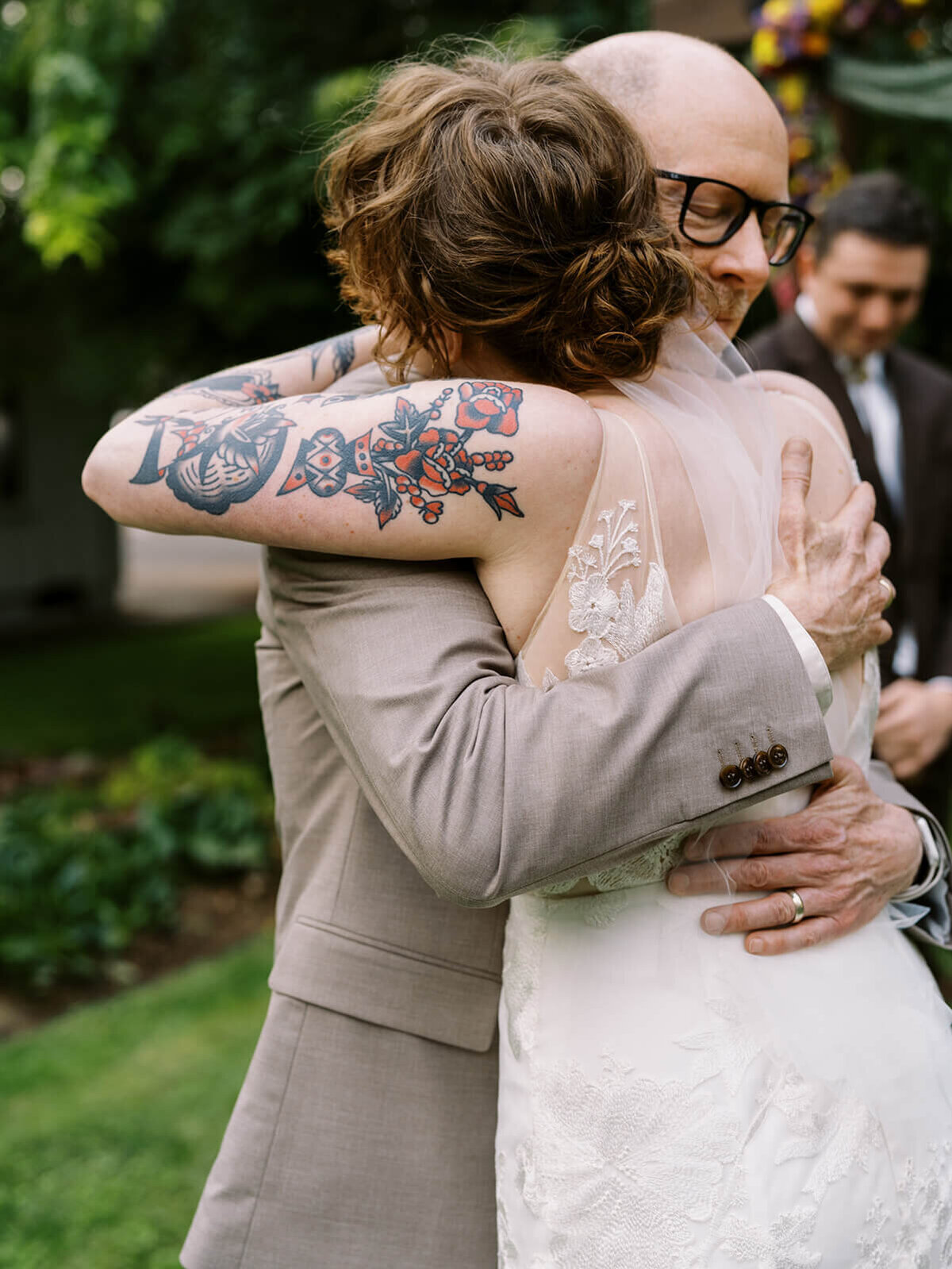 A bride hugging her father on her wedding day. 