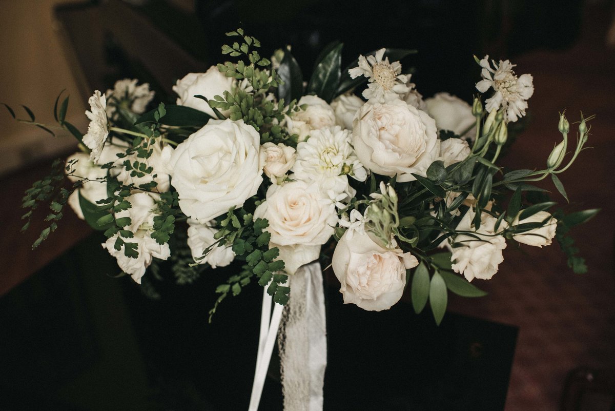 overgrown bouquet of all white roses, spray roses, nd local garden flowers with long ivory ribbon streamers