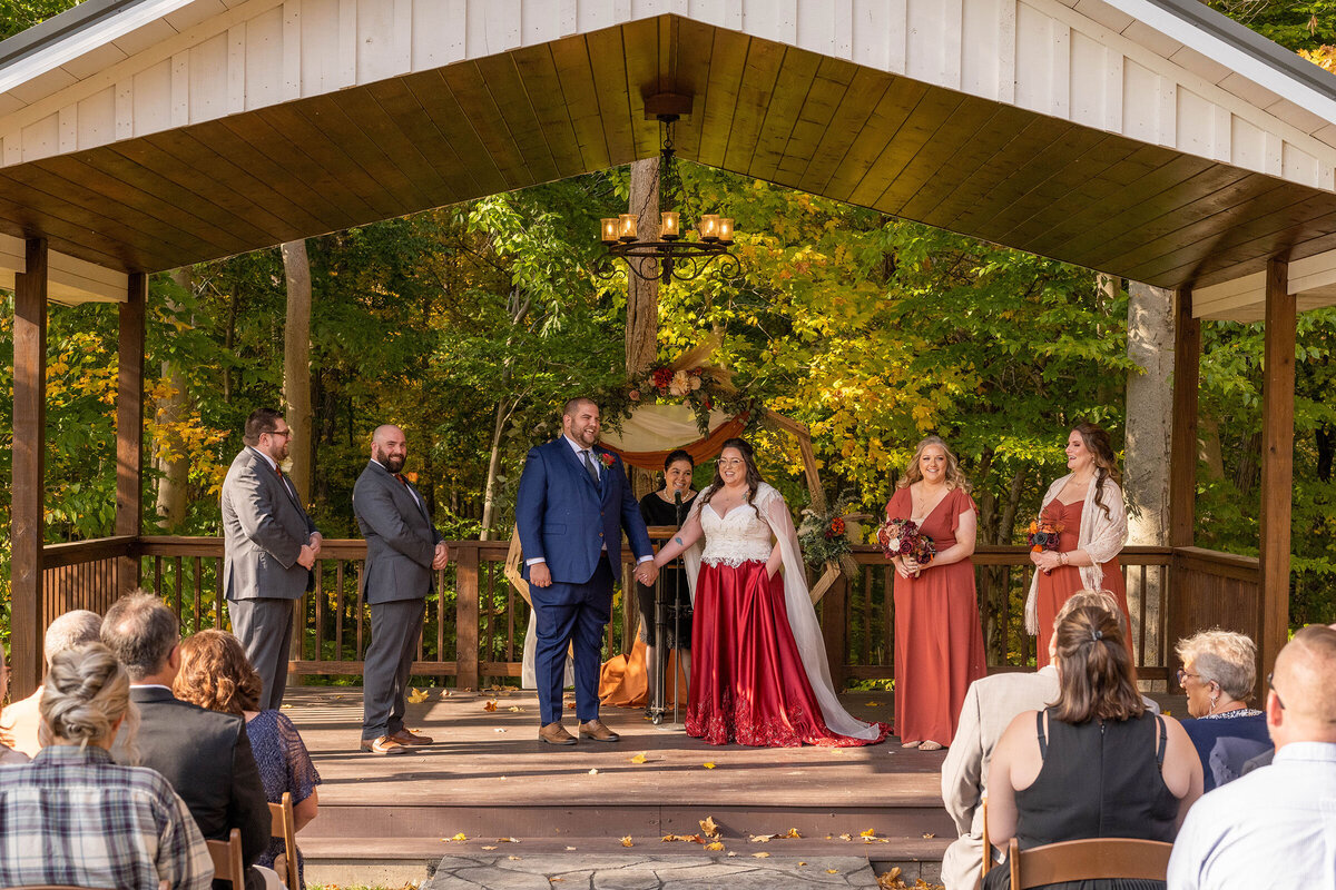 Indiana Wedding Photography of the bride and groom with their wedding party under the pavilion for their outdoor ceremony