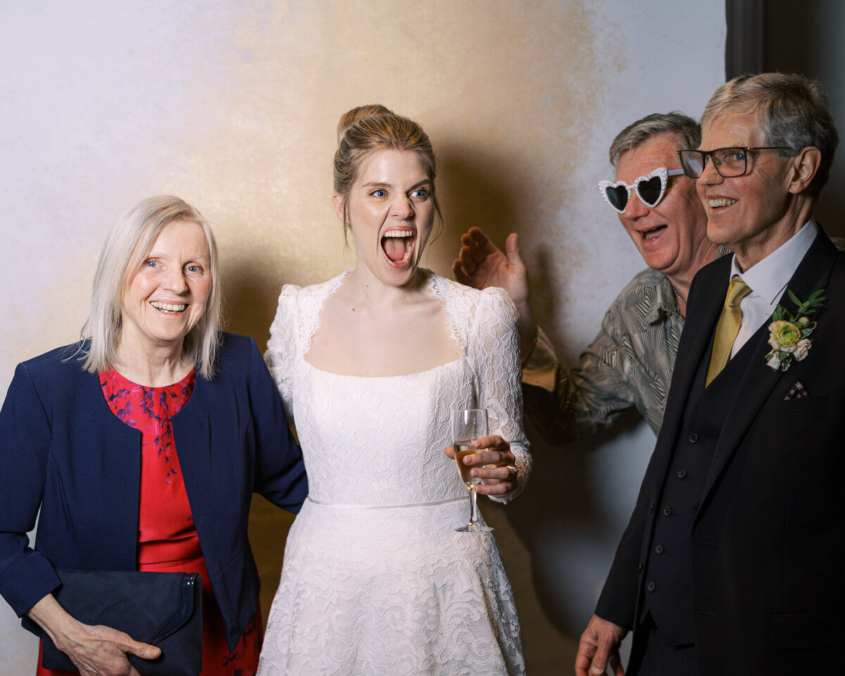 Bride and wedding guests in wedding portrait studio wedding photobooth