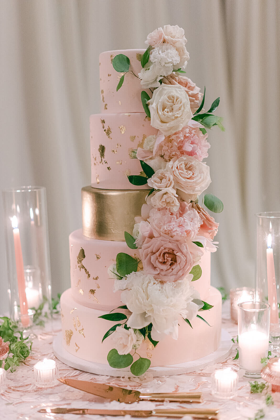 Blush and gold five-tiered wedding cake with floral details