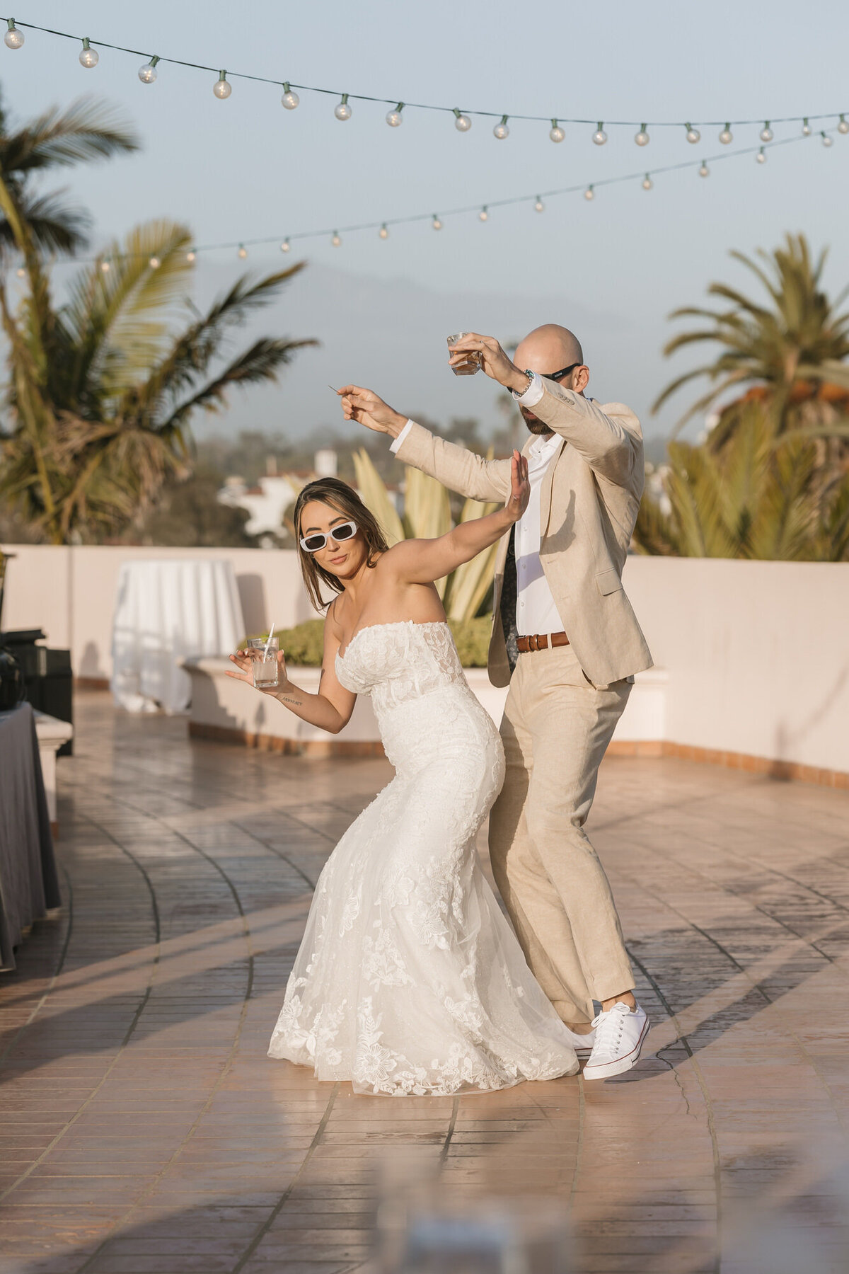 Bride and groom dancing together during grand entrance to wedding reception at Hilton Beachfront Resort Santa Barbara