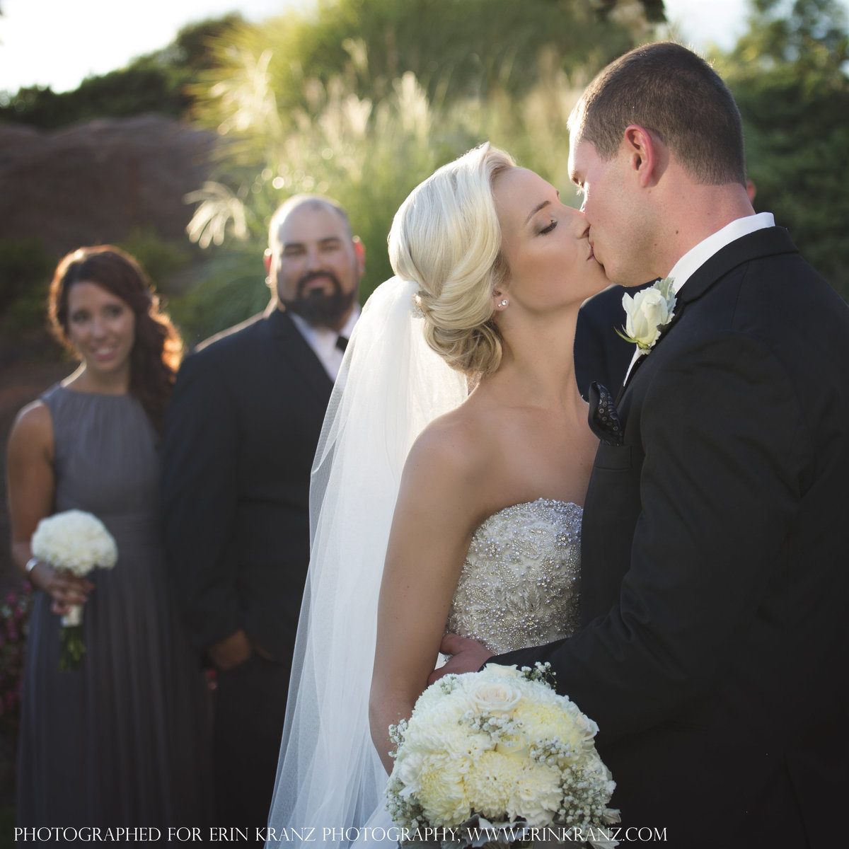 charlotte wedding photographer jamie lucido captures an image of the bride and groom kissing at an outdoor wedding Pine Island Country Club