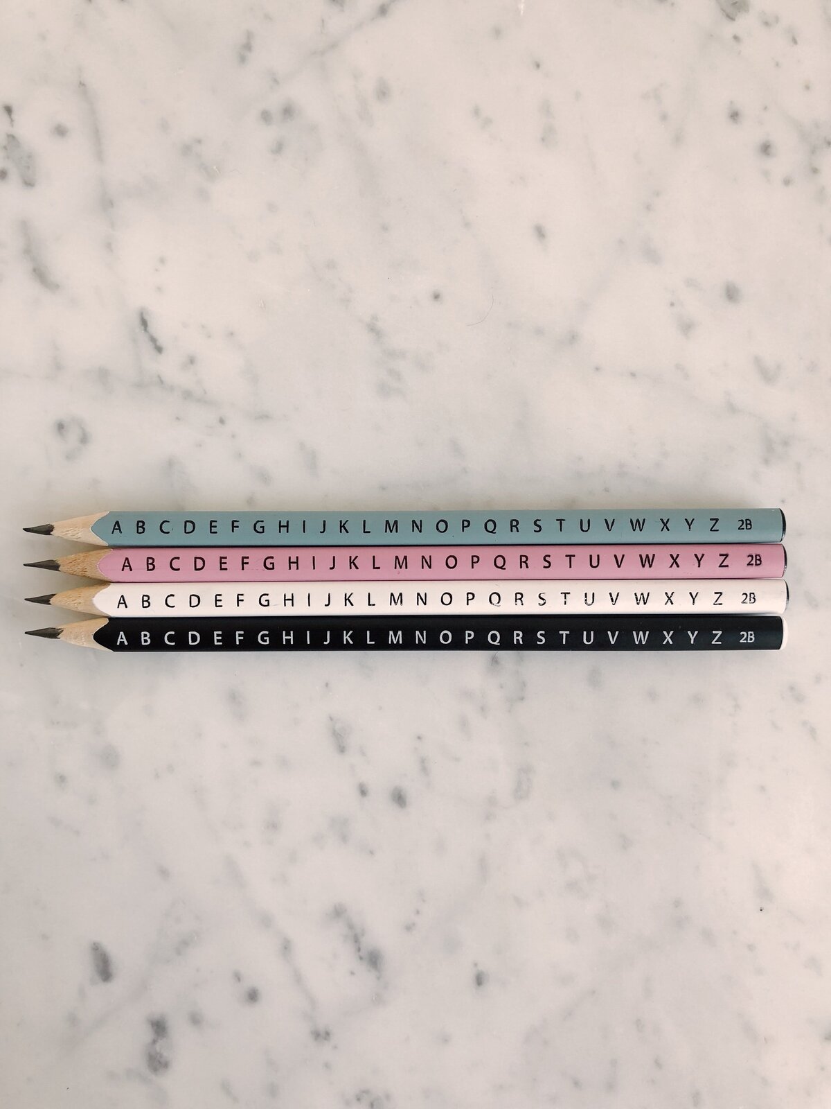 photo-of-four-pencils-on-marble-tiles-1029806