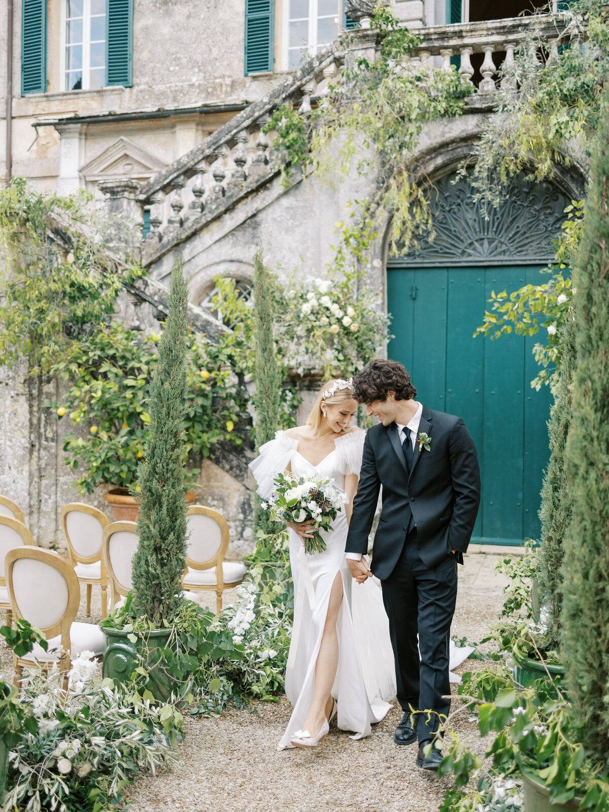 bride and groom walk down aisle together after ceremony at Villa Cetinale in Tuscany