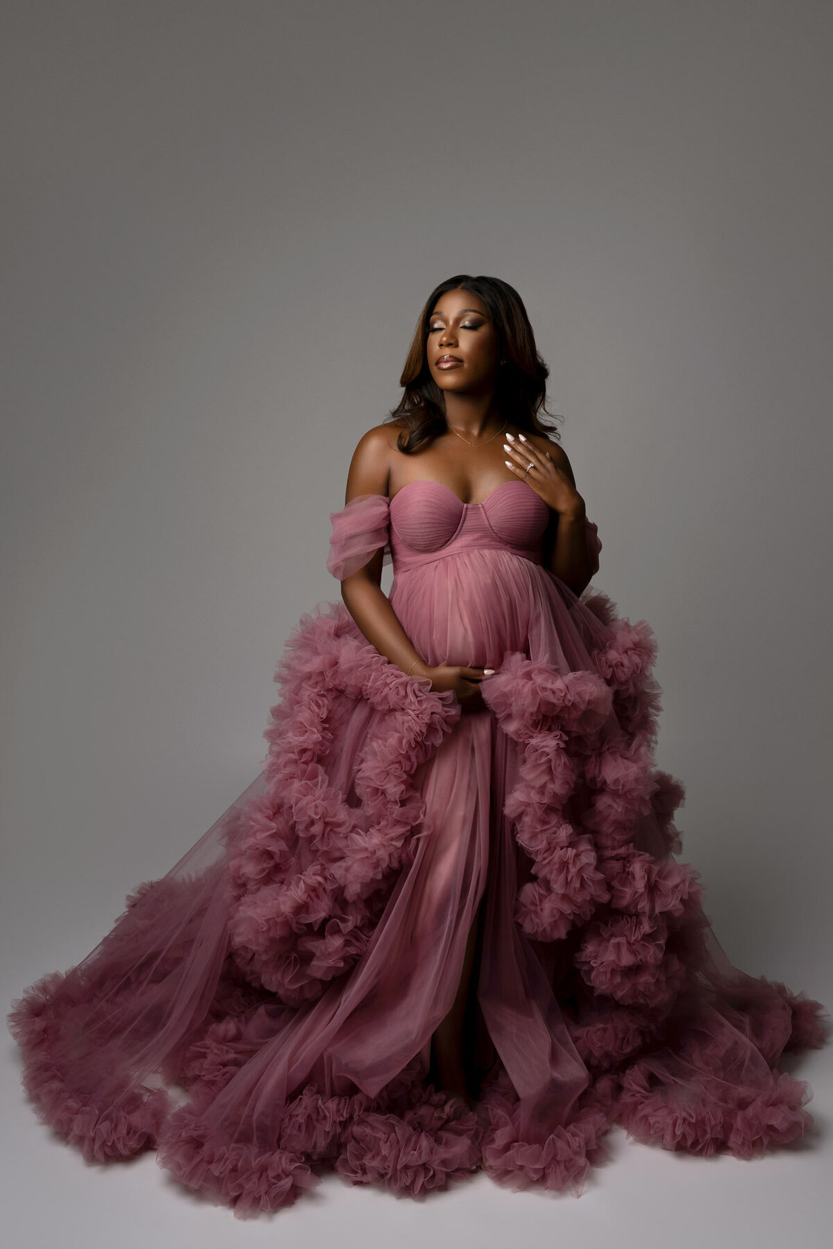 Austin maternity photography featuring tulle pink gown from professional client wardrobe at Cedar Park studio