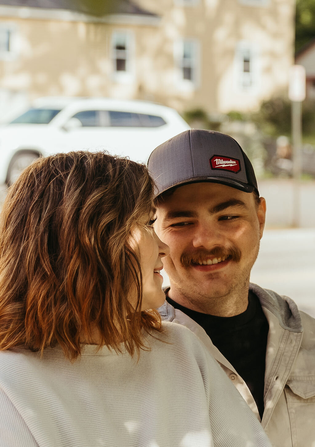 Photo of couple laughing together on bench