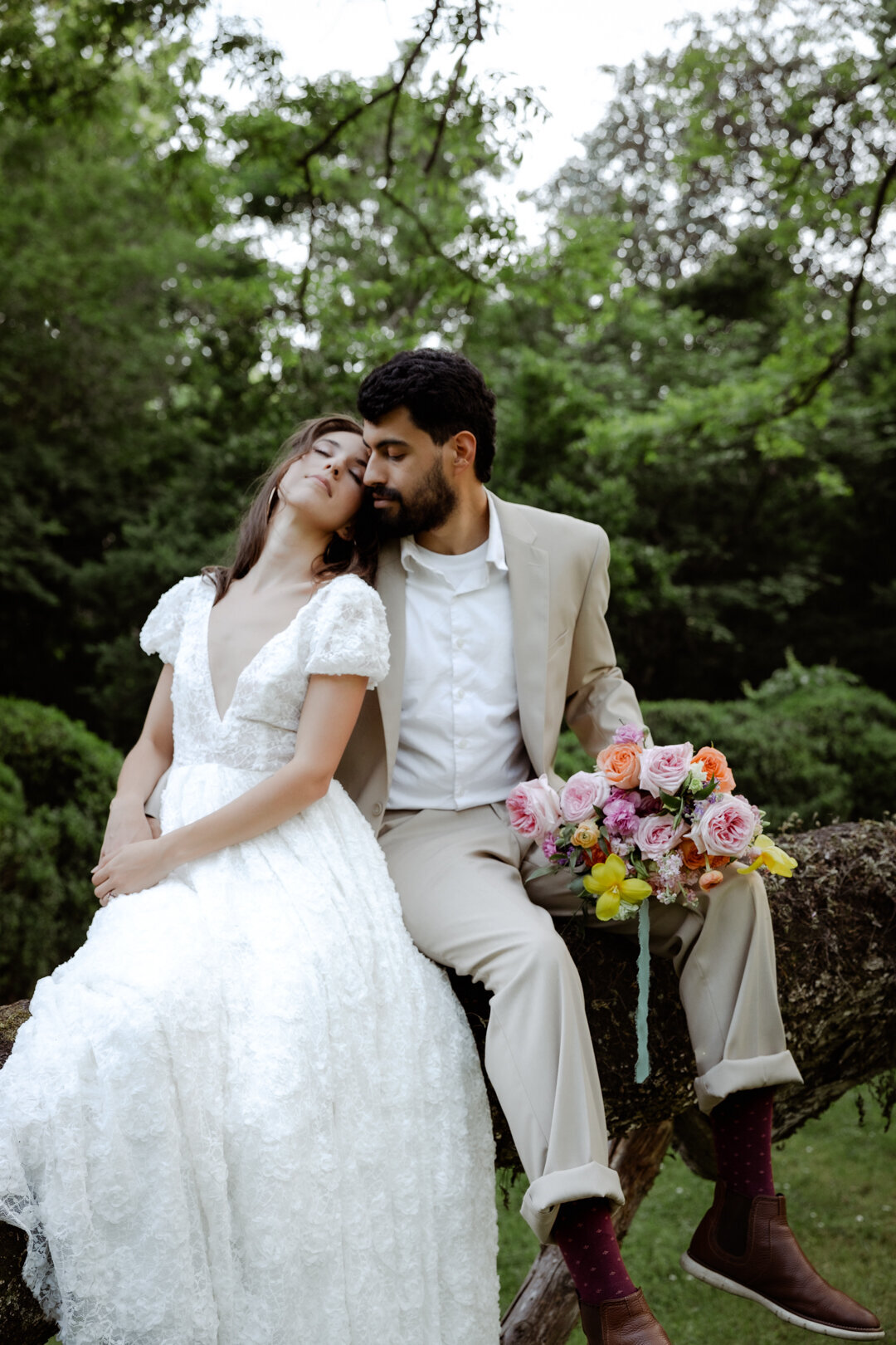 Bride and groom smiling together in a lush green garden during their spring elopement in Atlanta.