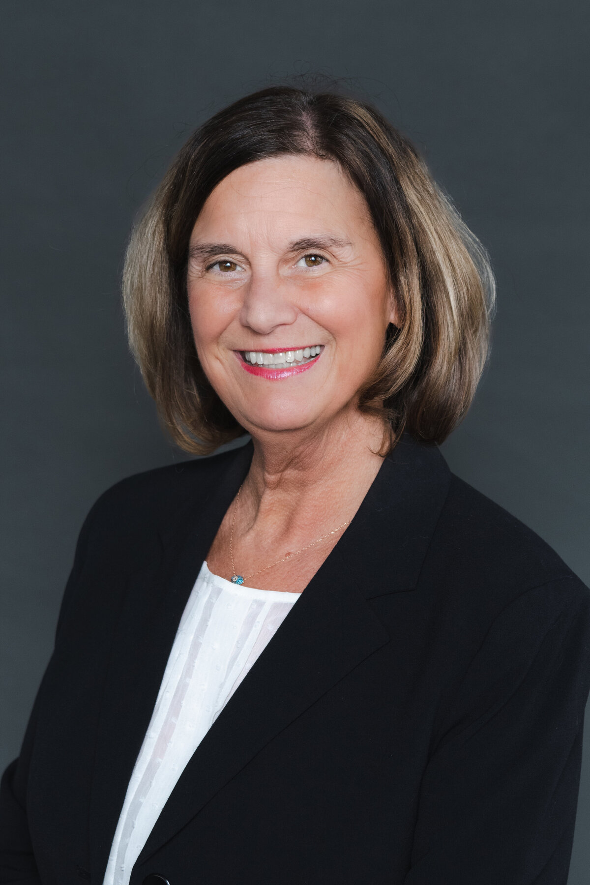 woman headshot on gray backdrop