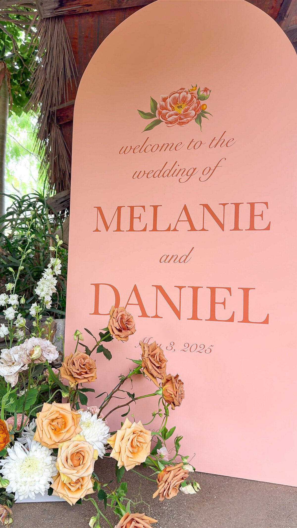Large welcome sign in coral pink with florals surrounding it at San Diego Safari Park San Diego Zoo Safari Park.