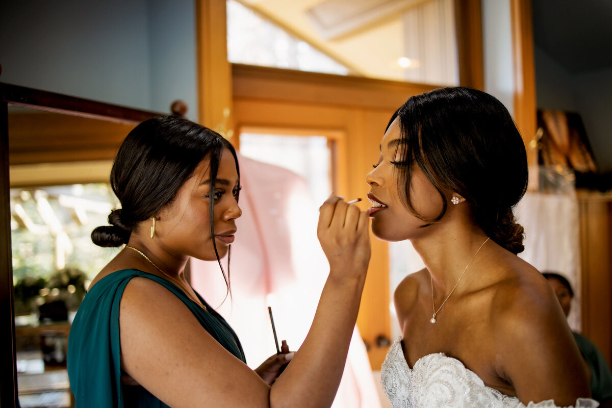 a bride perfects her wedding day makeup