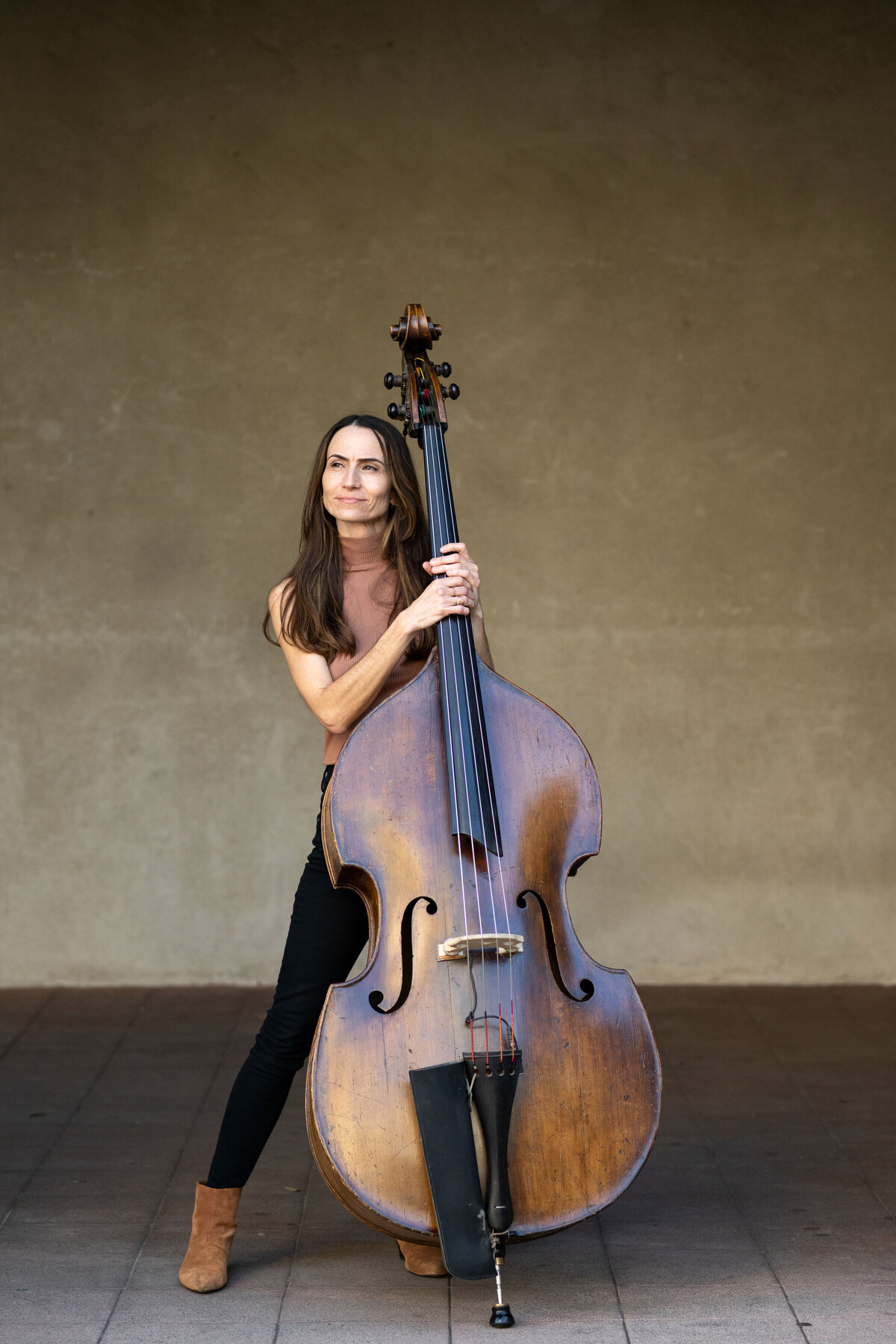 Professional Bass play poses with an upright acoustic bass in Balboa Part for an artistic portrait