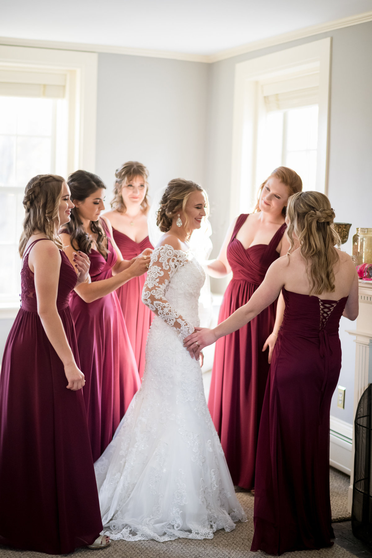 bride and bridesmaids in burgundy dress