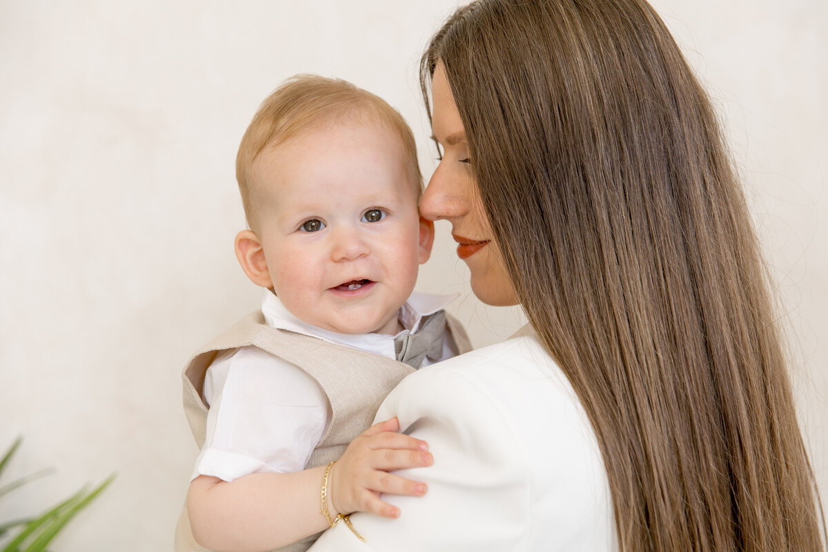 Happy baby with mother during studio photo session in the London studio.
