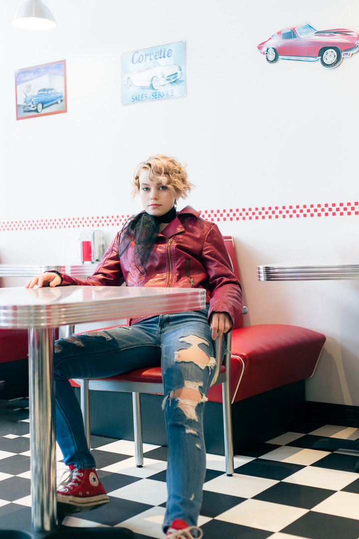 senior session at a diner with red jacket